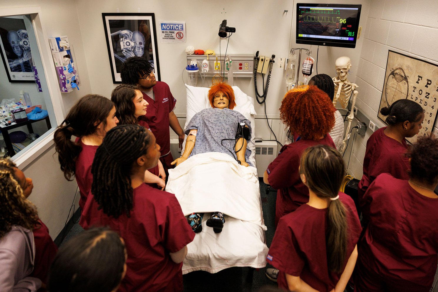 Students working together to help a simulated ailing patient.