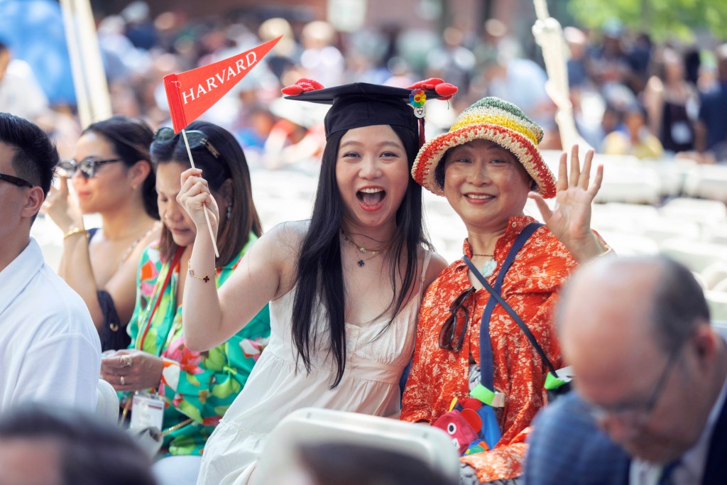 Lucie Zhuxi Wang, HGSE ’23 and her mother cheer during Harvard Alumni Day, 2023.
