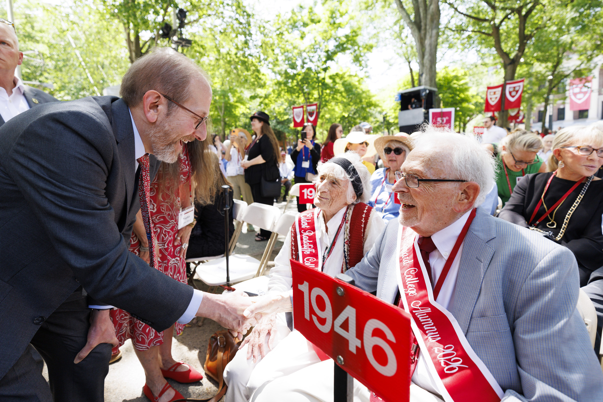 President Alan Garber greets the oldest alums in attendance at Harvard Alumni Day, Linda Cabot Black and Bill Dubey.