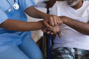 Young healthcare worker assisting an older patient.