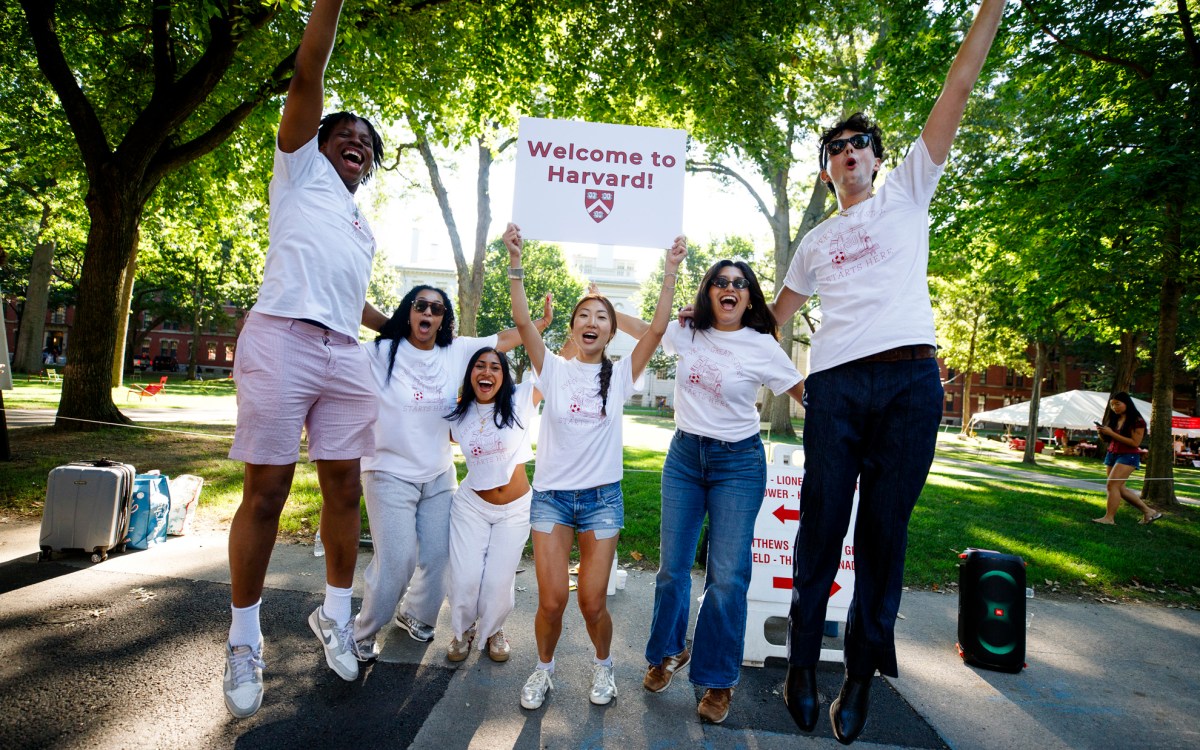 Members of the Crimson Key Society welcome first-year students to Harvard.