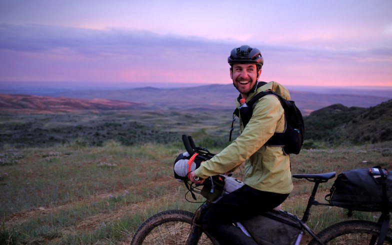 George Usmanov rides at sunset through southern Wyoming for the Tour Divide.