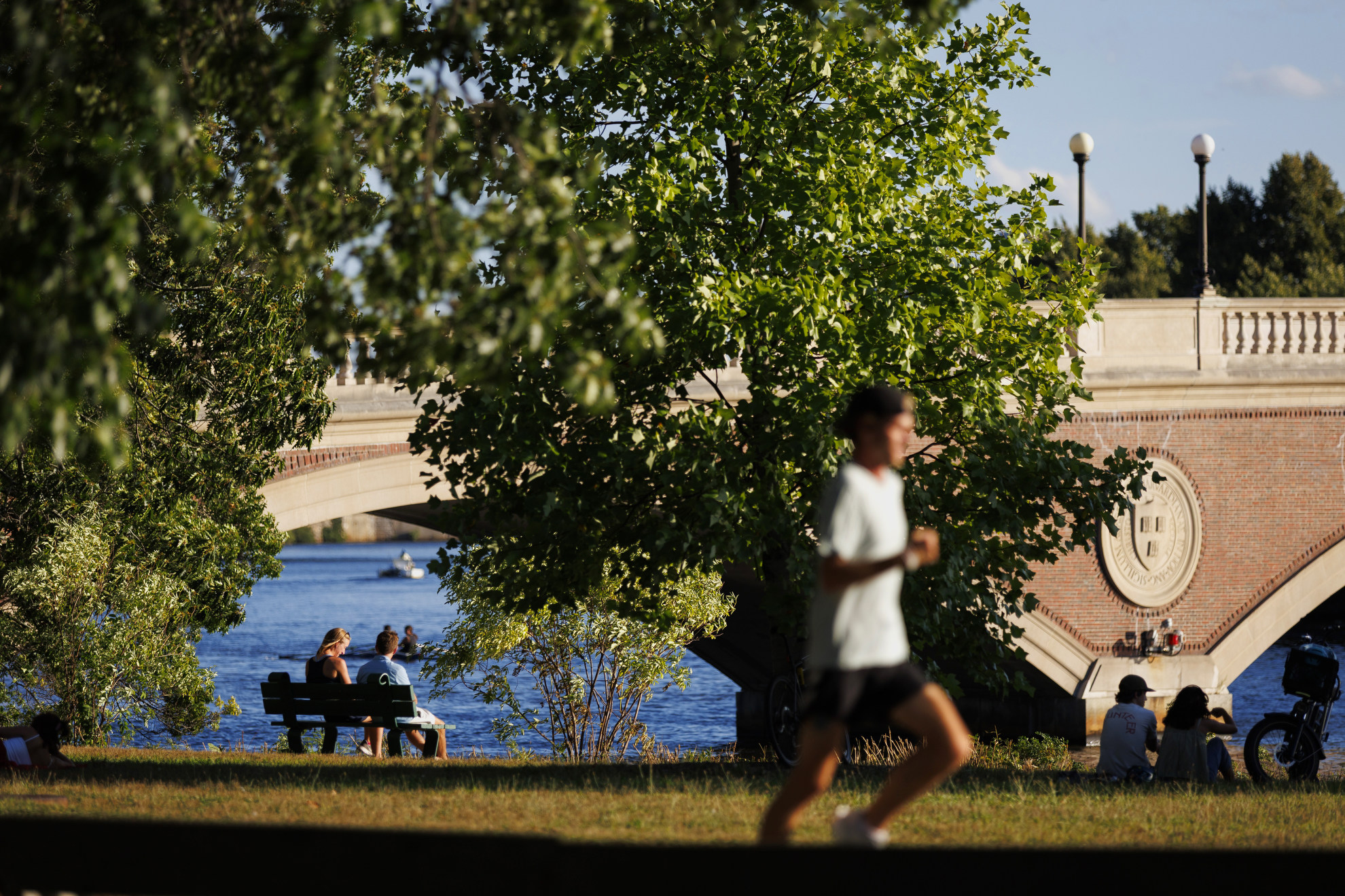 People gather at the end of the day alongside the Weeks Footbridge.