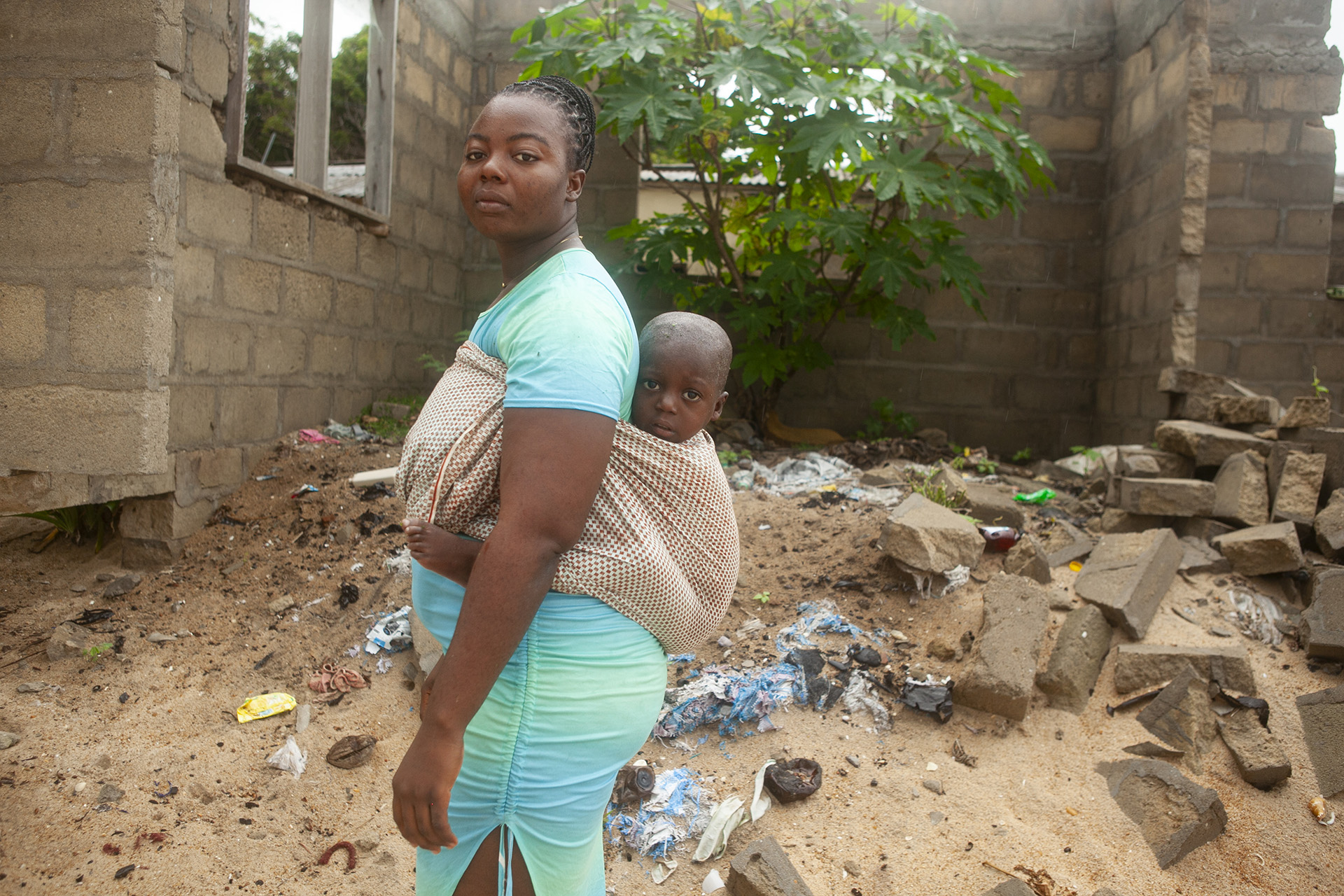 Josephine Domevenu carrying a child on her back.