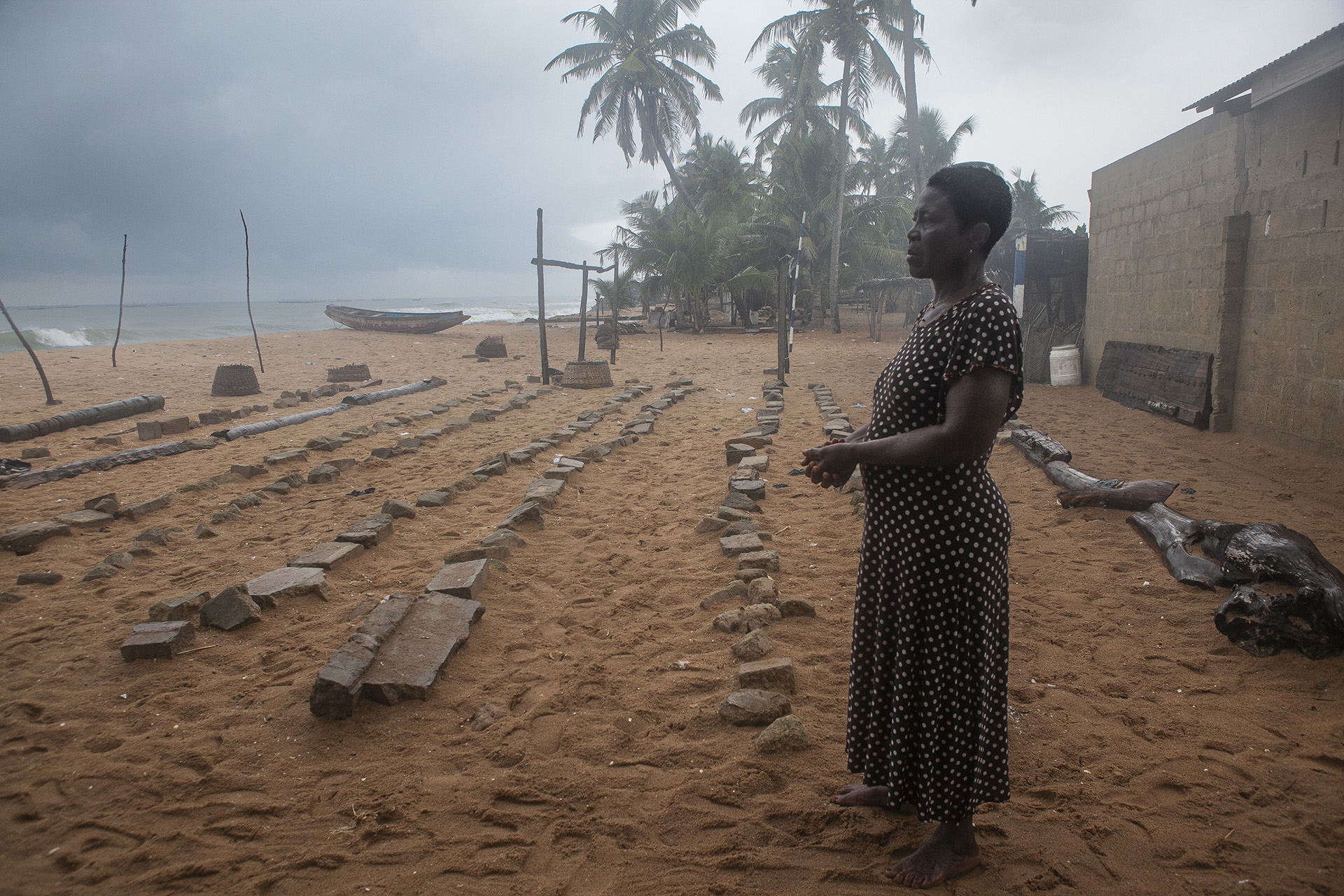 Kwashiwor Dansa looks out at the sea with groynes nearby.